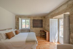a bedroom with a large bed and a piano at Feel Discovery Casa da Granja Douro Valley in Resende +101 photos