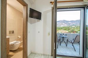 a room with a balcony with a table and chairs at Panorama in Elafonisi