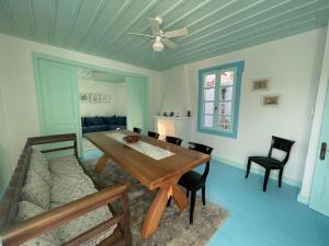 a dining room with a table and a couch at The Captains Residence in Poros