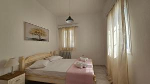 a small bedroom with a bed and a window at Sunny Home in Naxos Chora