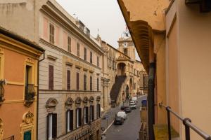 a view of a city street with cars parked on the street at Boca Luxury Rooms in Tarquinia