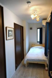 a bedroom with a bed and a window at Private Hotel Asakusa in Tokyo