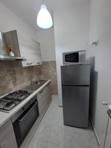 a kitchen with a stainless steel refrigerator and a microwave at Principe Umberto in Contursi Terme
