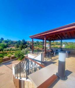 a pavilion with a table and chairs on a roof at Villa Elizabeth in Limassol