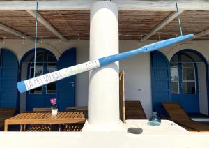 a street sign hanging off the side of a building at La Mia Valigia a Stromboli in Stromboli
