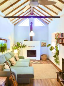 a living room with a couch and a fireplace at El Encanto in Monachil
