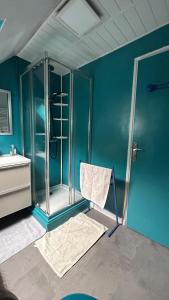 a bathroom with a glass shower and a chair at Entre terre et mer in Combrit +36 photos