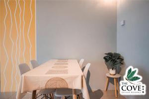 a dining room with a table and chairs at Ipoh Tambun Waterpark Apartment The Cove Hillside in Ipoh