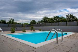 a swimming pool in a backyard with a fence at Holiday home Olive Hill in Brig