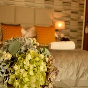 a bouquet of flowers on a table in a hotel room at Le Bouchon Brasserie & Hotel in Maldon