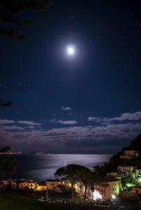 a full moon rising over the ocean at night at Casa Vacanze Bouganvillea in Cetara