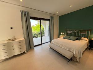 a bedroom with green walls and a bed and a window at Villa Carla in Cefalù