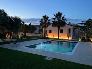a swimming pool in the yard of a house at Villa Carla in Cefalù