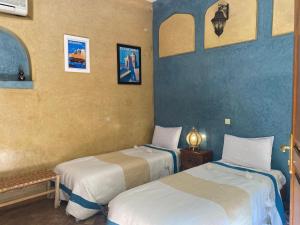 Postel nebo postele na pokoji v ubytování Riad Sabah