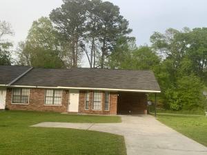 a brick house with a black roof and a driveway at Cheerful 2-bedroom 2 bath entire home West Rome in Rome
