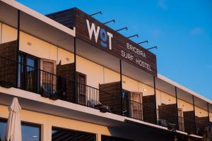 a building with aww sign on the side of it at WOT Ericeira Surf Hostel in Ericeira