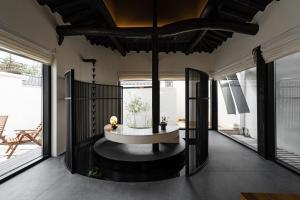 a living room with a round table and large windows at Stay Theoria in Jeonju
