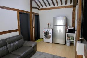 a living room with a refrigerator and a washing machine at Naju DorandoranHouse Hanok in Naju +9 photos