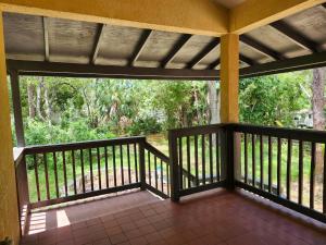 a porch with a view of the woods at la casa del bosque in Bradenton