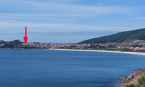 a red island in the middle of a body of water at Ático Alefriz in Fisterra