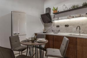 a kitchen with a table and chairs and a sink at Perth Luxury Living, Athens in Athens