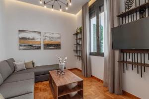 a living room with a couch and a table at Perth Luxury Living, Athens in Athens