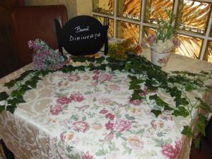 a table with a table cloth with flowers on it at Pensiunea Dapa in Predeal