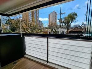 a large window with a white garage door in a building at Ap Moderno Ap 21 Soho Life in Curitiba