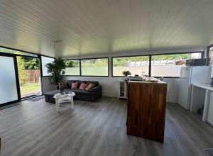 a living room with a couch and a table at Logement agréable sur Le Teich in Le Teich