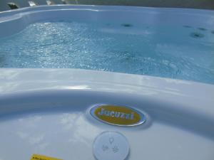 a bath tub filled with water with anatural sign on it at Terrazze Naos in San Leone