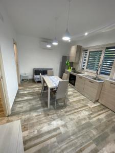 a kitchen and dining room with a table and chairs at Muschiaturo in Foce Varano