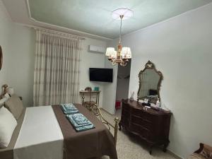 a bedroom with a bed and a mirror and a dresser at Casa Giulia in Porto SantʼElpidio
