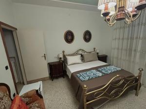 a bedroom with a bed and a chandelier at Casa Giulia in Porto SantʼElpidio