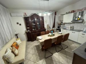a kitchen and dining room with a table and chairs at Casa Giulia in Porto SantʼElpidio
