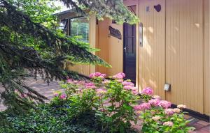 a bunch of pink flowers in front of a house at Huize Roland in Sint Annaland
