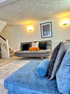 a living room with two couches and a blue couch at Mount Yard - Stylish Cottage - Close to Alton Towers - Peak District - Stoke-on-Trent Sleeps 5 in Totmonslow