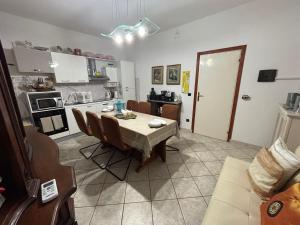 a kitchen and dining room with a table and chairs at Casa Giulia in Porto SantʼElpidio