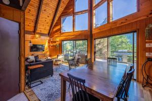 a dining room and living room with a large wooden table at Hygge Haus Sequoia - Large Private Cabin w Views in Ponderosa