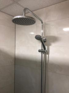 a shower with a shower head in a bathroom at C&E Apartment in Struga +23 photos
