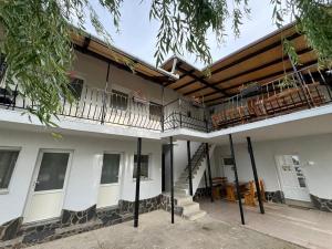 a building with a balcony and stairs on it at Casa Barry's in Tăşnad