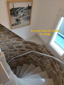 a staircase in a house with a picture on the wall at Le 1 St Yves Studios in Tréguier +8 photos