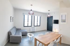 a living room with a table and a couch at Argolis Stone Homes in Kranidi