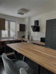 a kitchen with a wooden table and a chair at U Fera in Stará Bystrica