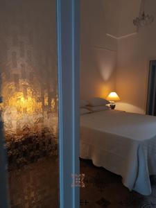 a bedroom with a bed with a painting on the wall at Domus Donata in Galatone +44 photos