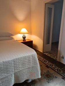 a bedroom with a bed and a lamp on a table at Domus Donata in Galatone