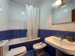 a blue and white bathroom with a toilet and a sink at La Ensenada de Meruelo - 2805 in San Miguel de Meruelo +19 photos