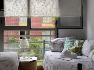 a living room with a couch and a window at La Ensenada de Meruelo - 2805 in San Miguel de Meruelo
