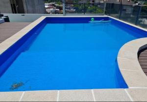 a blue swimming pool on top of a building at Carilo in Villa Carlos Paz