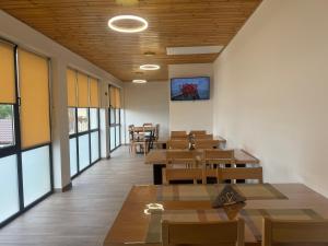 a dining room with tables and chairs and windows at Casa Cristal Sulina in Sulina +17 photos