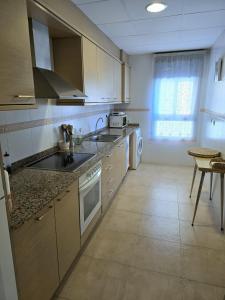 a kitchen with a sink and a stove top oven at Maestrat13 in Peñíscola